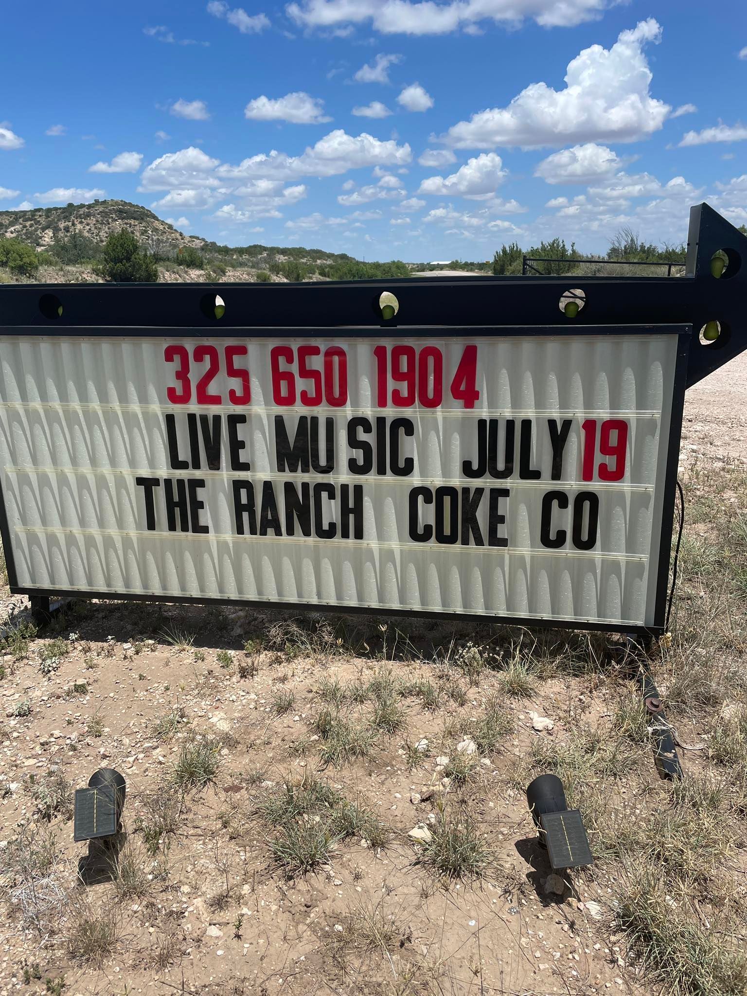 Marquee sign reading “LIVE MUSIC JULY 19” and “THE RANCH COKE CO,” with phone number above.