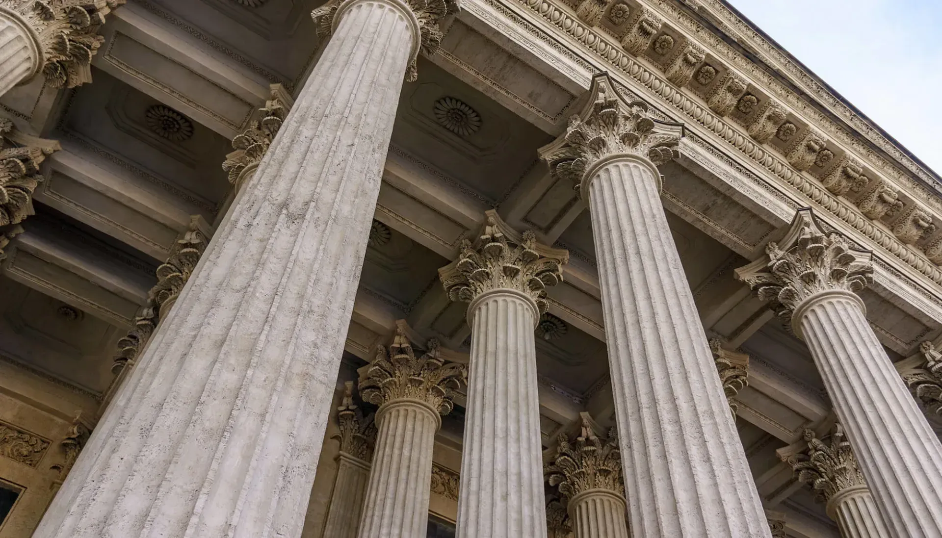 Low-angle view of tall fluted stone columns on a classical building facade