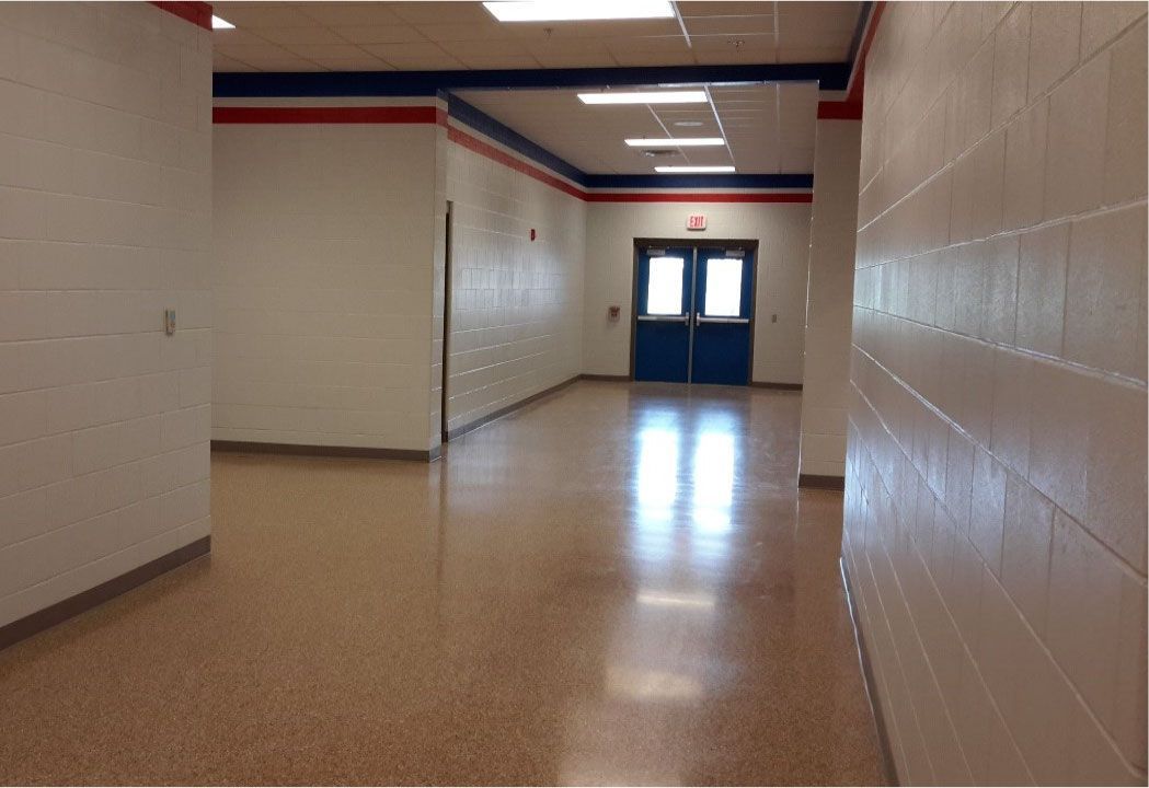 An empty hallway with a blue door in the middle