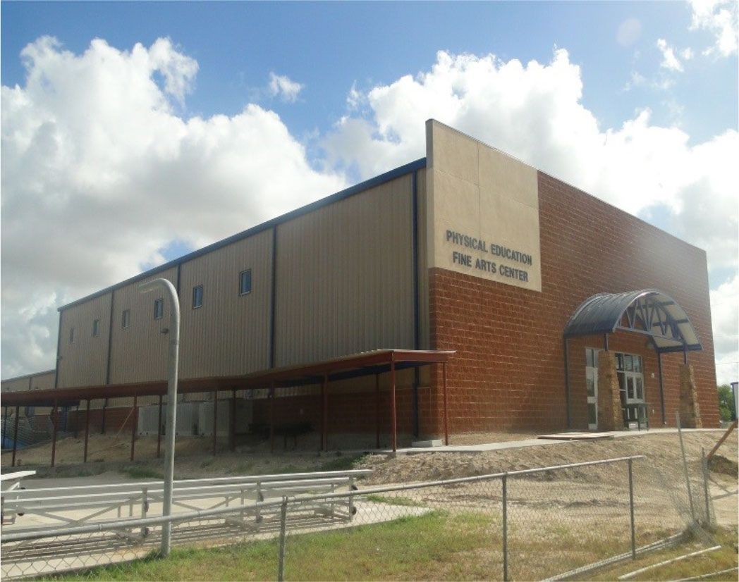A large brick building with a fence around it
