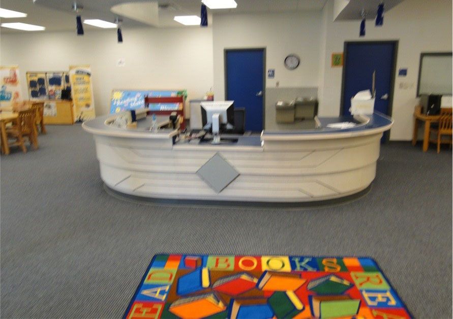 A library with a rug that says books on it