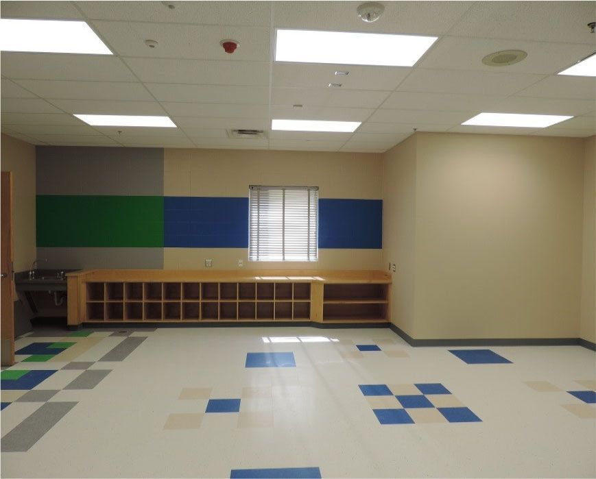 An empty room with a blue green and white checkered floor