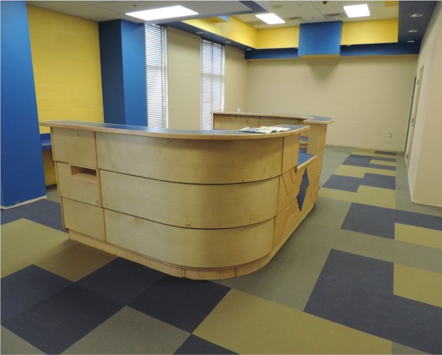 A reception desk in a room with blue and yellow walls