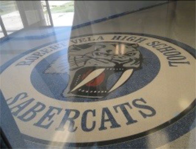 Sabercats logo on the floor of a high school