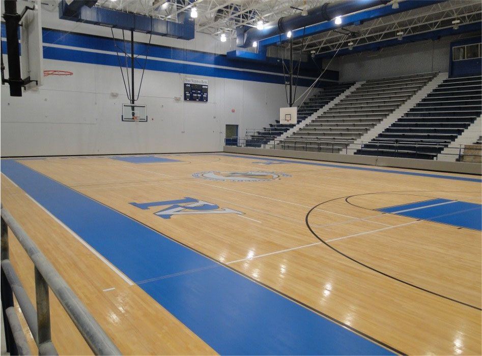 A basketball court in a gym with the word ucsd painted on the floor