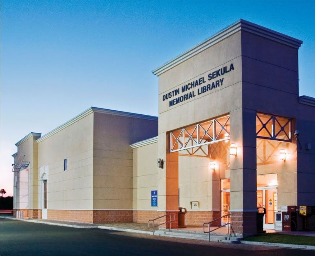 The dustin michael sexula memorial library is lit up at night