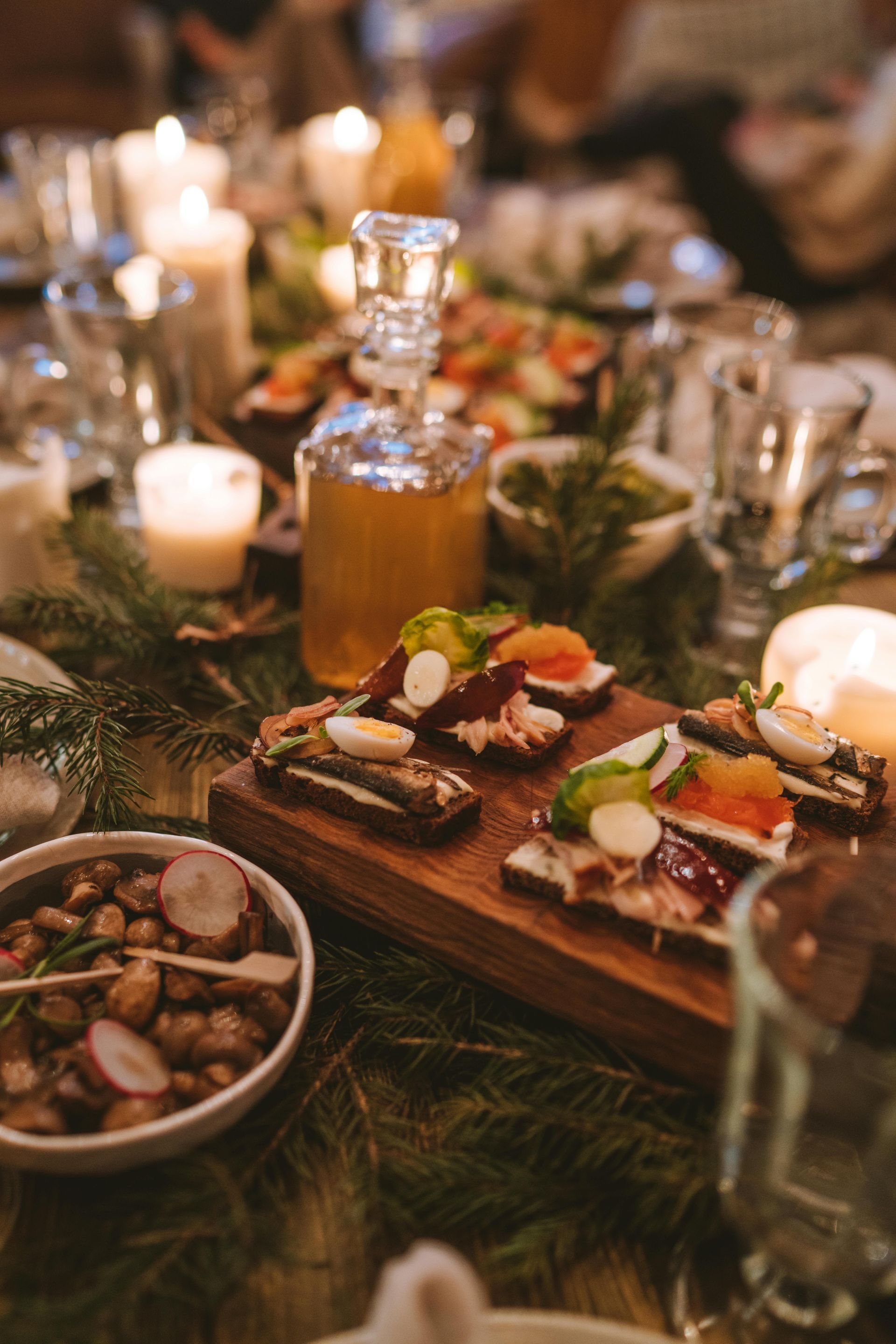 A table topped with a variety of food and candles.