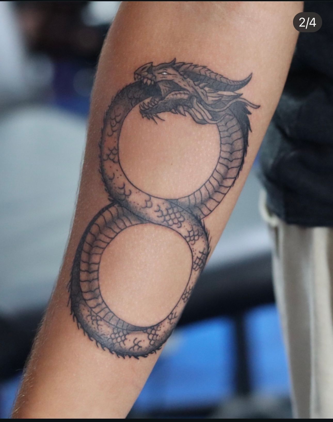 A person has an infinity tattoo on their arm