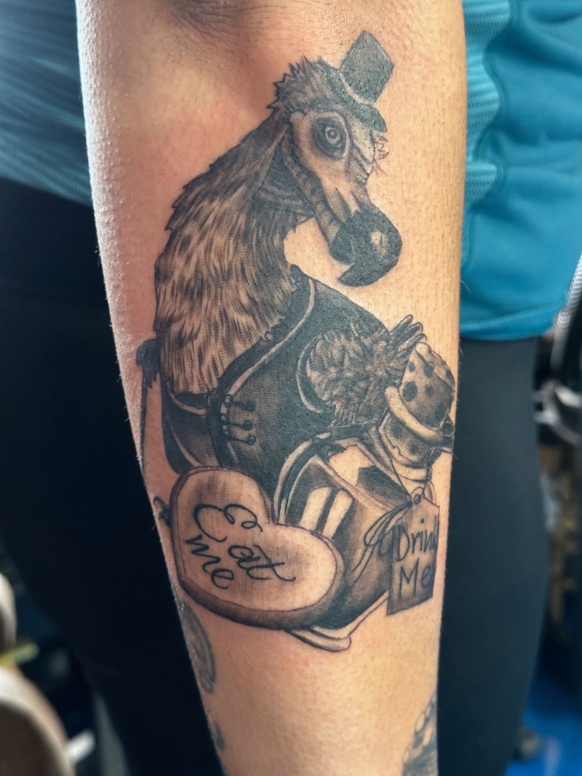 A person has a tattoo of a horse that says eat me