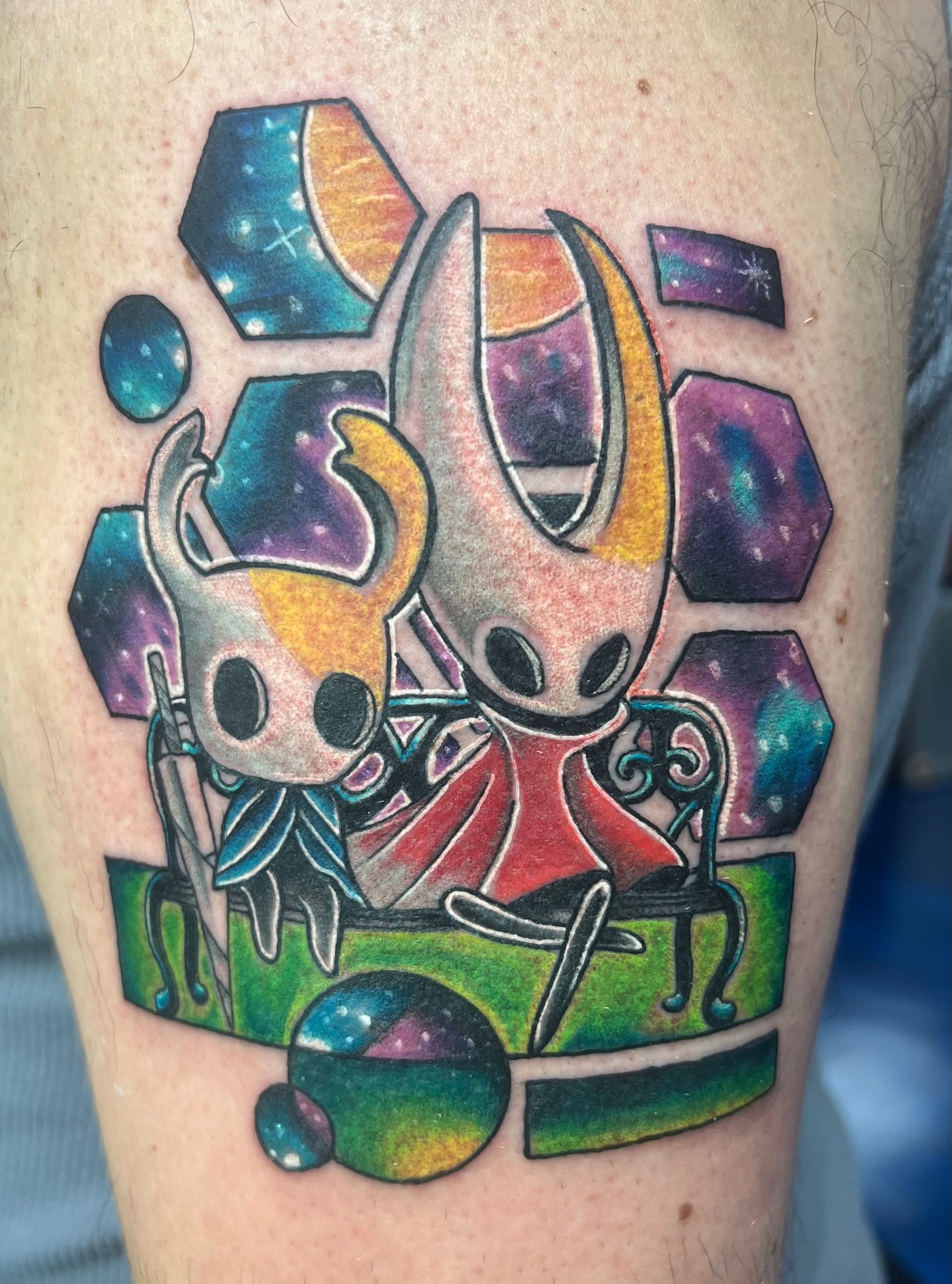 A tattoo of a knight and a hornet on a person 's leg.