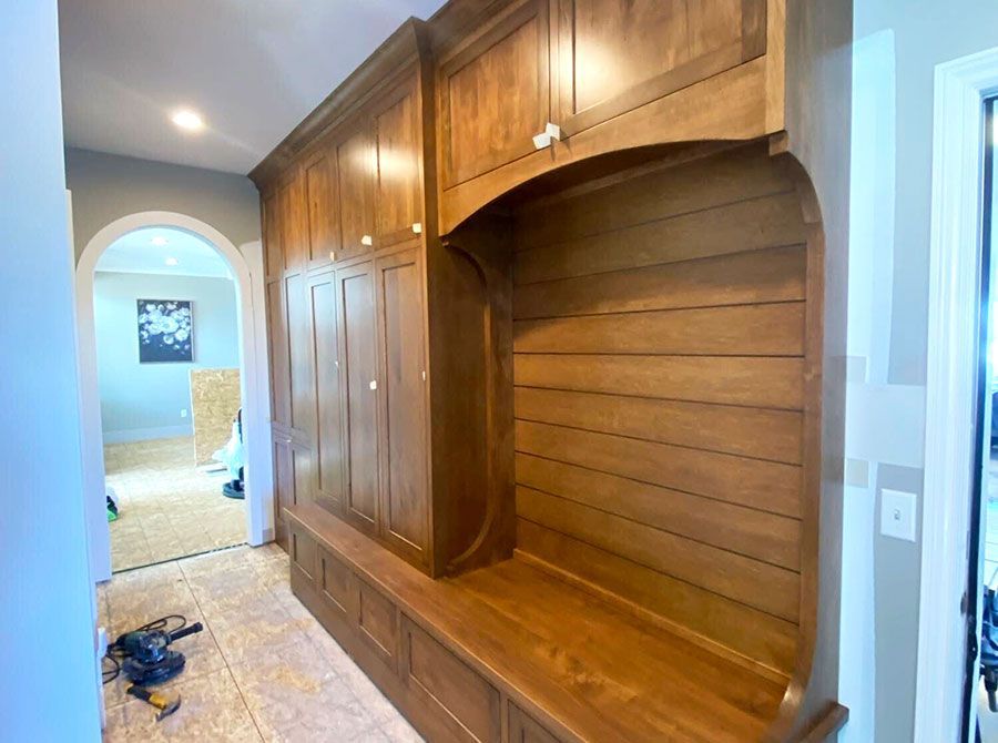 Several white doors and beige slatted panels arranged in a room, like storage or display partitions.