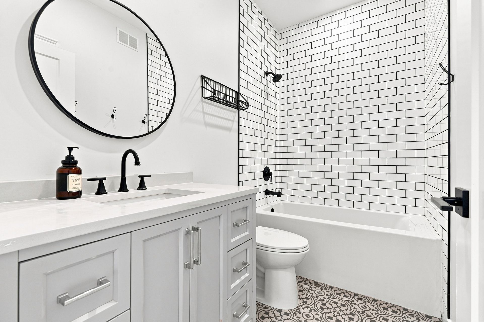 Modern bathroom with walk-in shower, white tile, and wood vanity cabinet