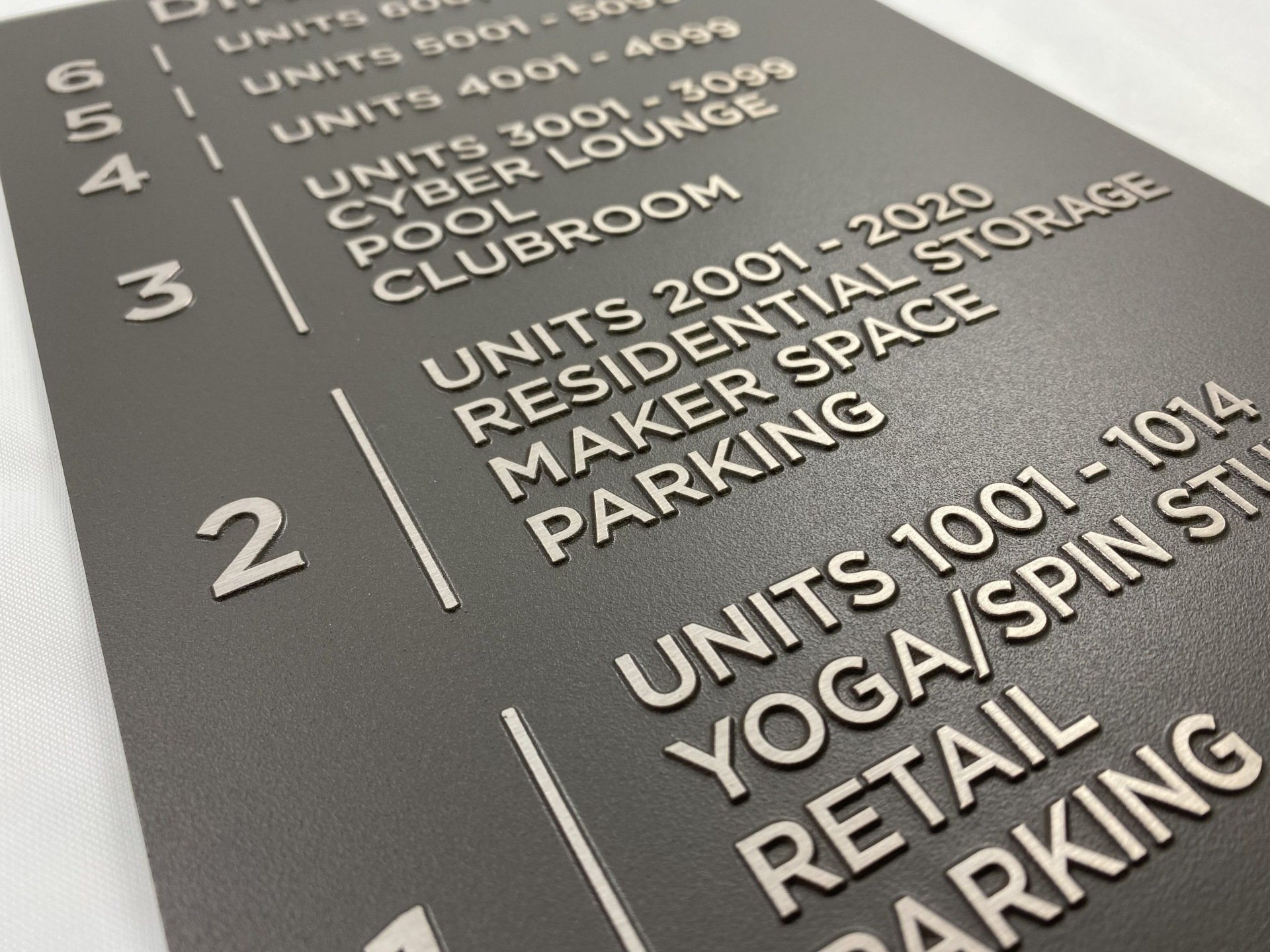 BRUSHED NICKEL TINT BUILDING SIGNAGE | VisionMark Nameplate Company