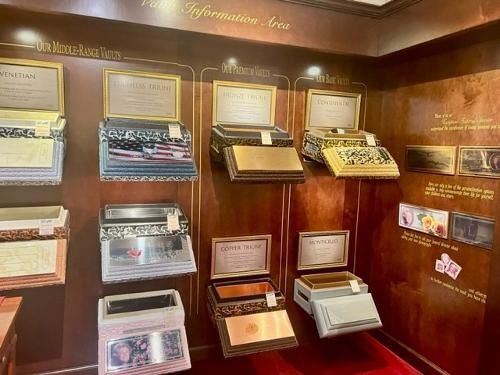 Wood-paneled museum display of vintage typewriters and framed plaques in glass cases