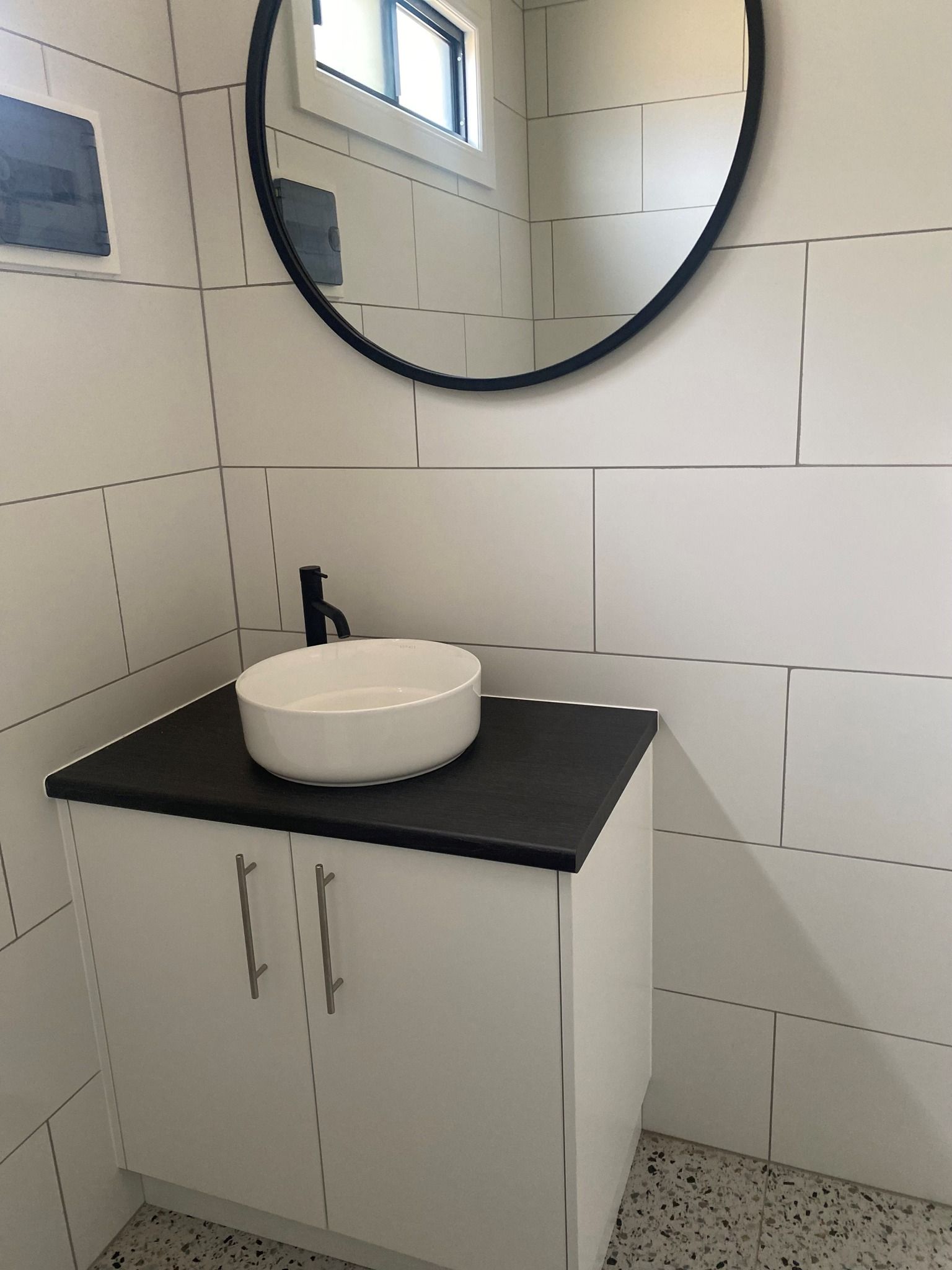 A White Sink and Cabinet With Black Countertop — Taylormade Constructions & Renovations In Kingaroy, QLD