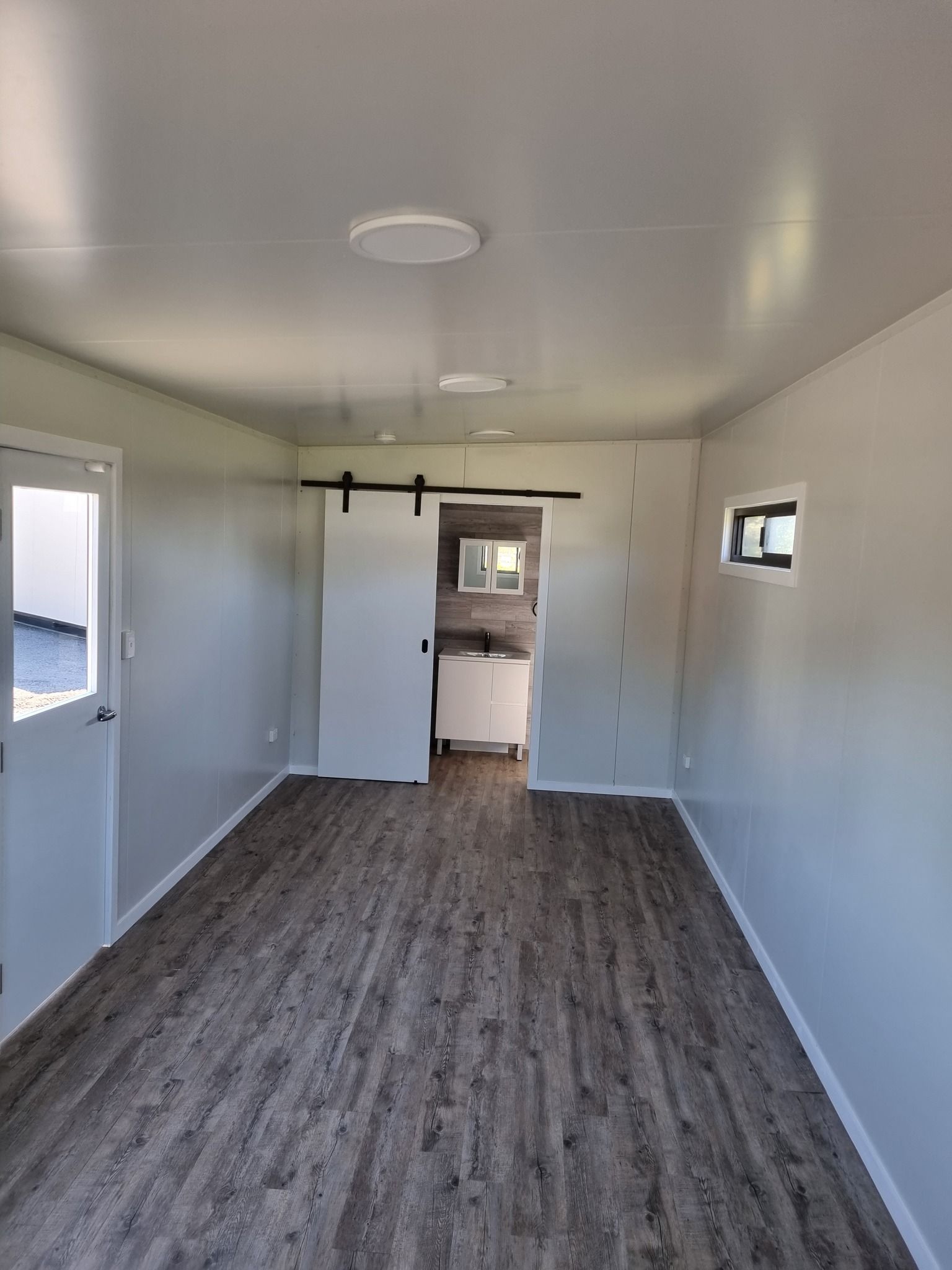 Interior of a Small Room With Grey Walls and Wood-look Floor — Taylormade Constructions & Renovations In Tarong, QLD