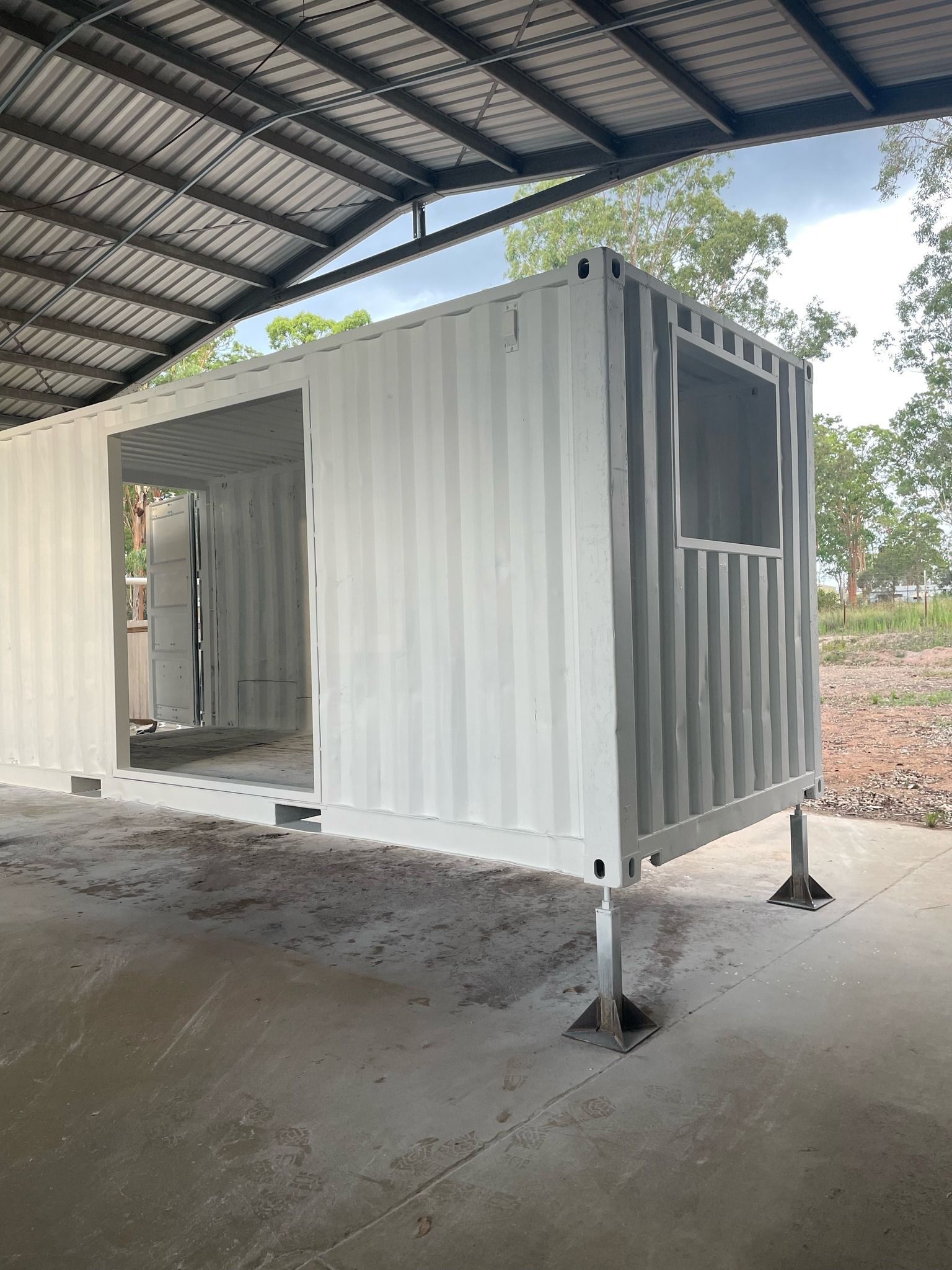 White Shipping Container With a Door and Window — Taylormade Constructions & Renovations In Goodger, QLD