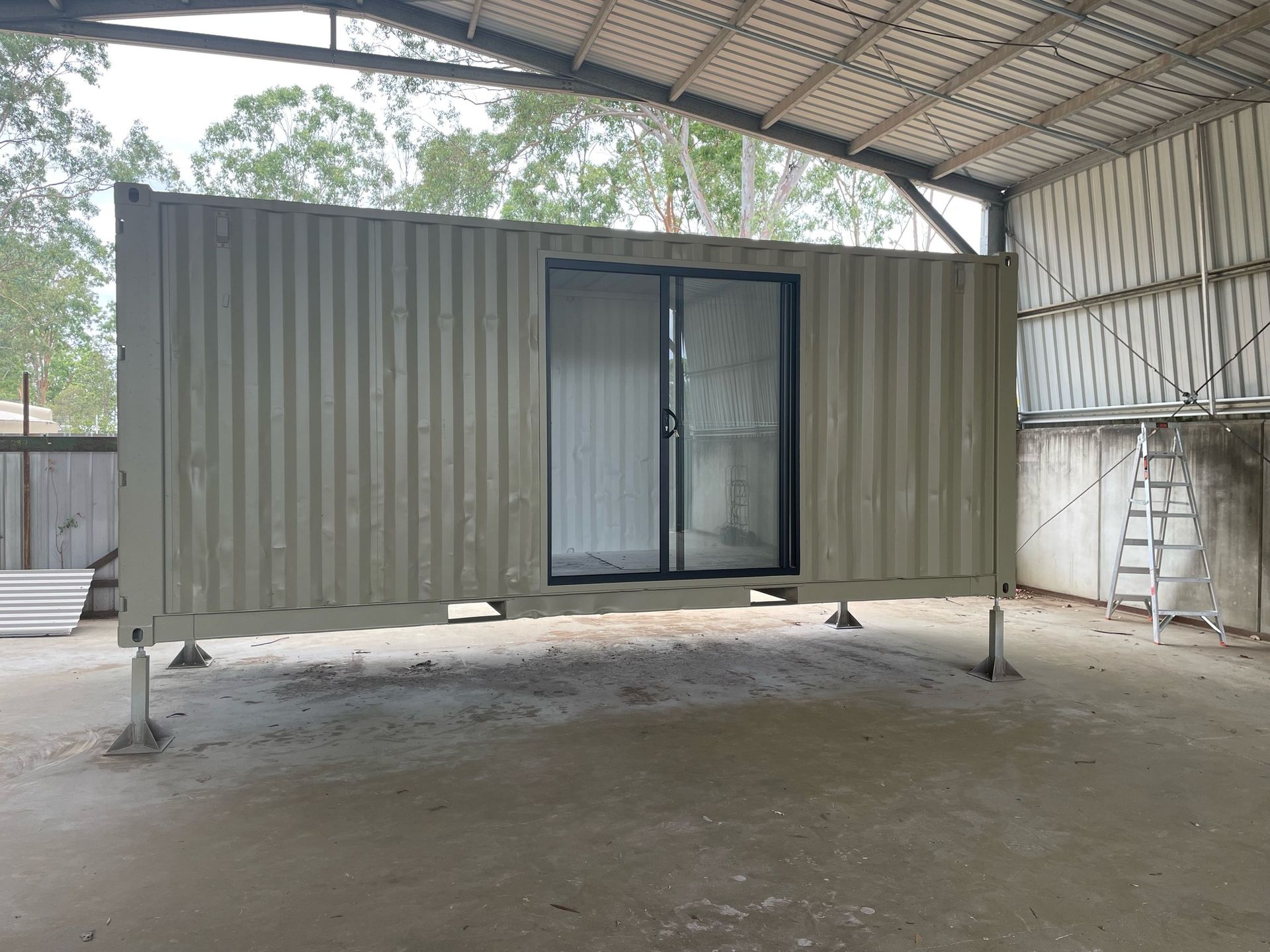Shipping Container With Sliding Glass Door, Inside a Warehouse — Taylormade Constructions & Renovations In Ellesmere, QLD