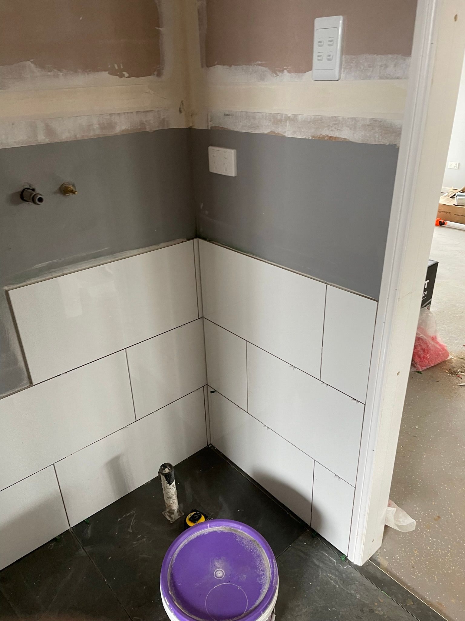 Corner of a Partially Tiled Wall With Grey Paint — Taylormade Constructions & Renovations In Blackbutt, QLD