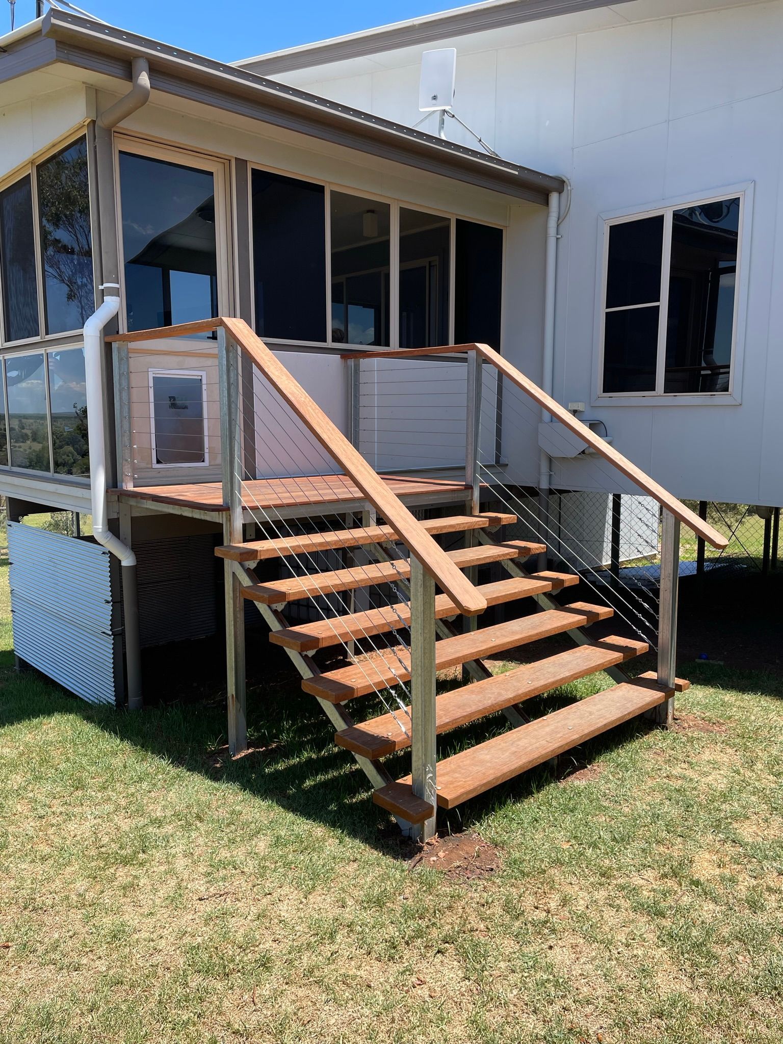 Wooden Stairs Leading Up to a White House With a Screened-in Porch — Taylormade Constructions & Renovations In Kingaroy, QLD