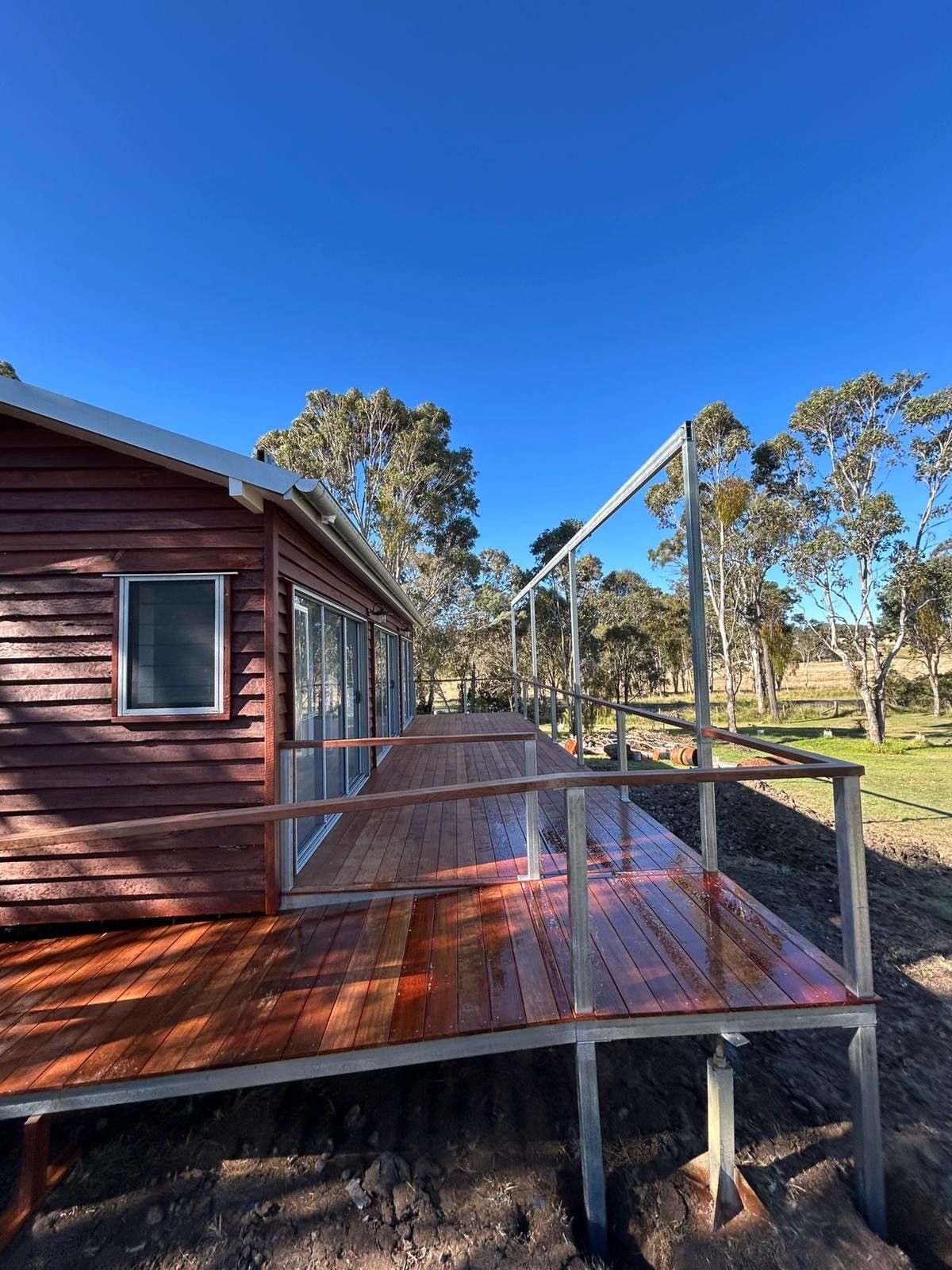 Wooden House With a Large Deck; Metal Railing — Taylormade Constructions & Renovations In Kingaroy, QLD