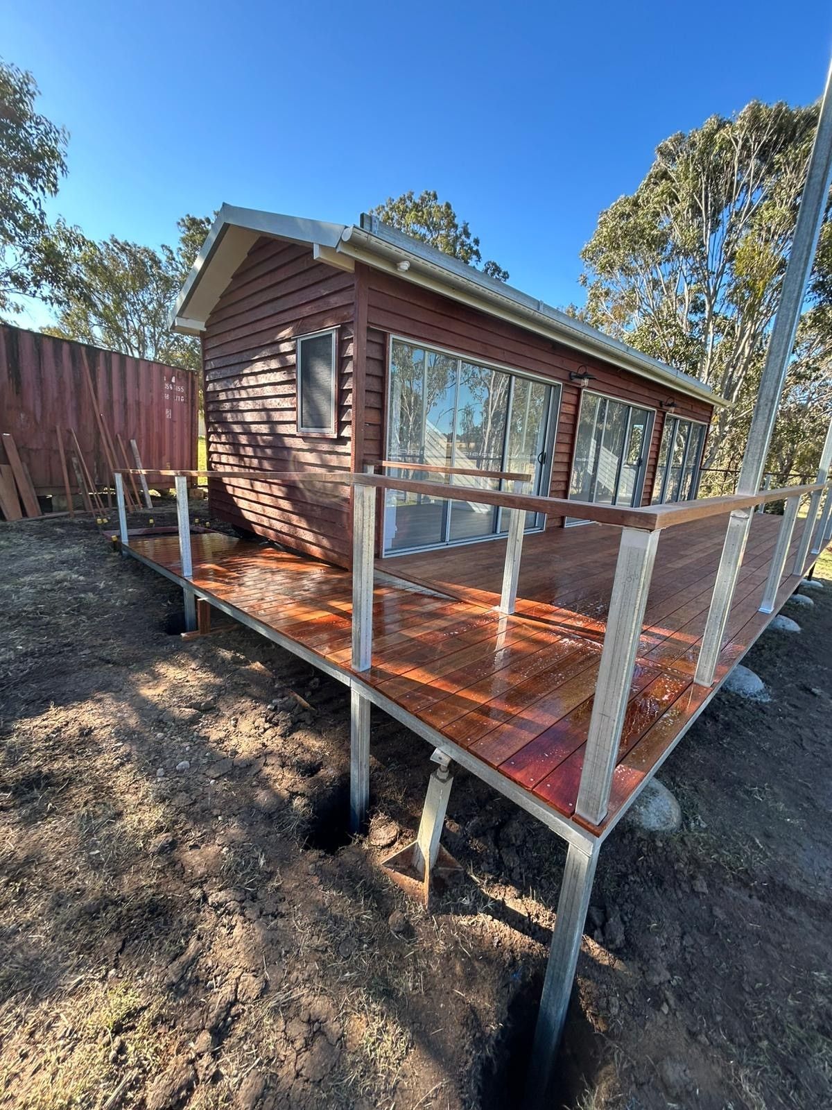 Wooden Cabin With Deck on Metal Supports — Taylormade Constructions & Renovations In Blackbutt, QLD