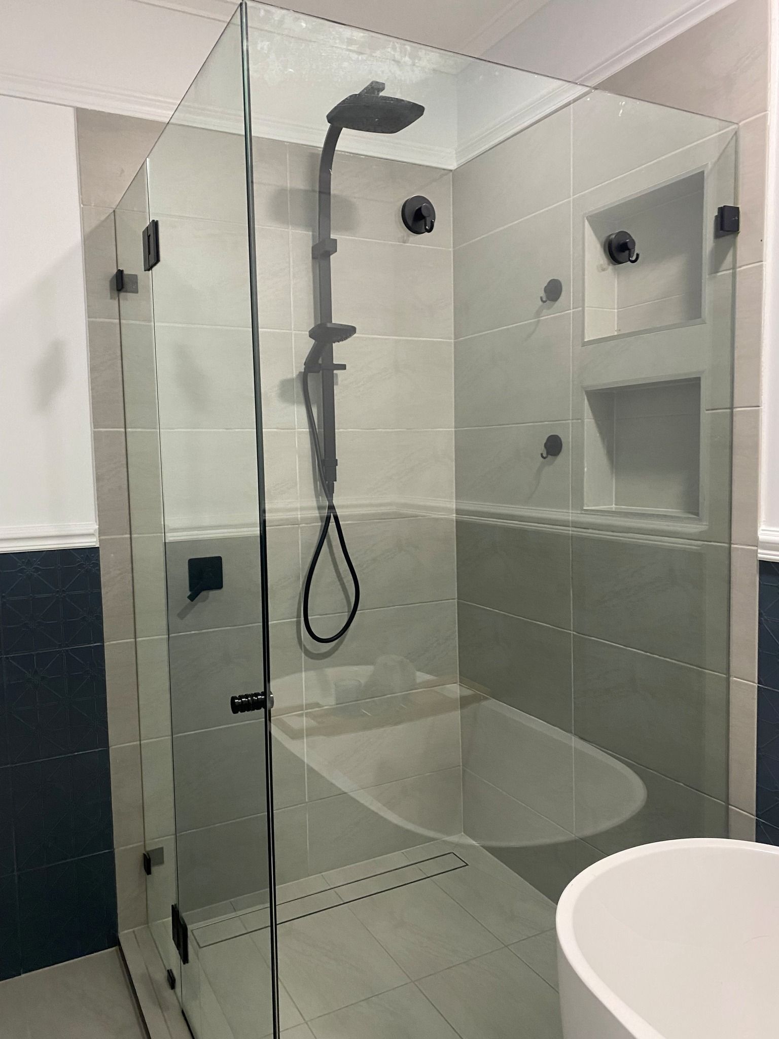 Bathroom With Glass Shower Enclosure, Black Fixtures, and White Tub — Taylormade Constructions & Renovations In Nanango, QLD