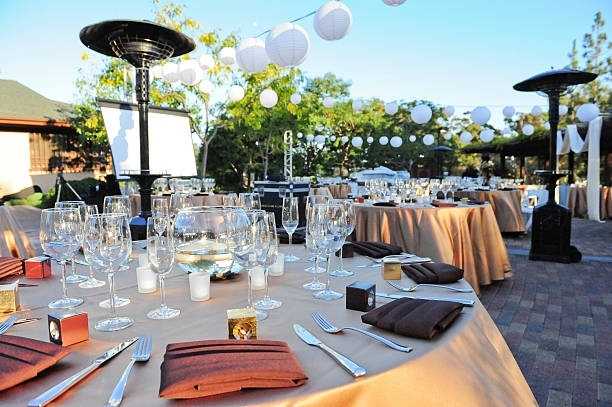 A table set up for a wedding reception with wine glasses and candles