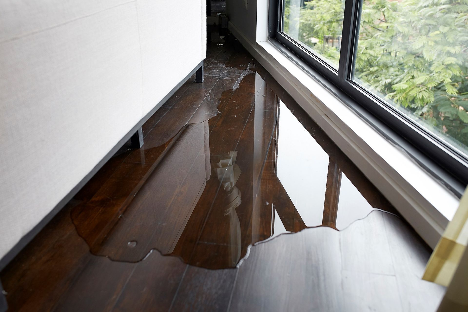 A room with a flooded floor and a window