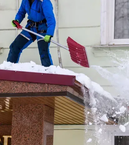 Commercial roof snow removal services to reduce snow accumulation and protect commercial buildings