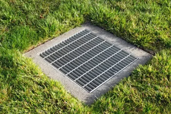 Property drainage systems designed to redirect excess water and reduce landscape flooding issues