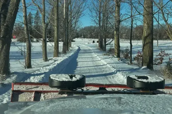 Residential snow removal service clearing snow from a home's driveway