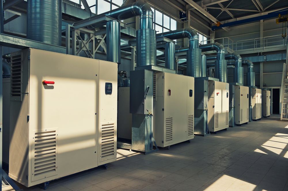 A Row of Machinery is Lined Up in a Factory — FVS Airconditioning & Electrical Pty Ltd in Ryan, QLD