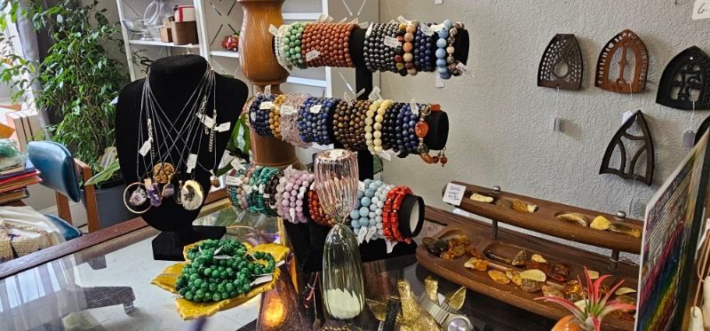 Display of colorful beaded jewelry and accessories on stands in a shop