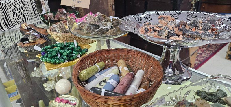 Assorted sweets and confections in baskets and silver trays on a market table