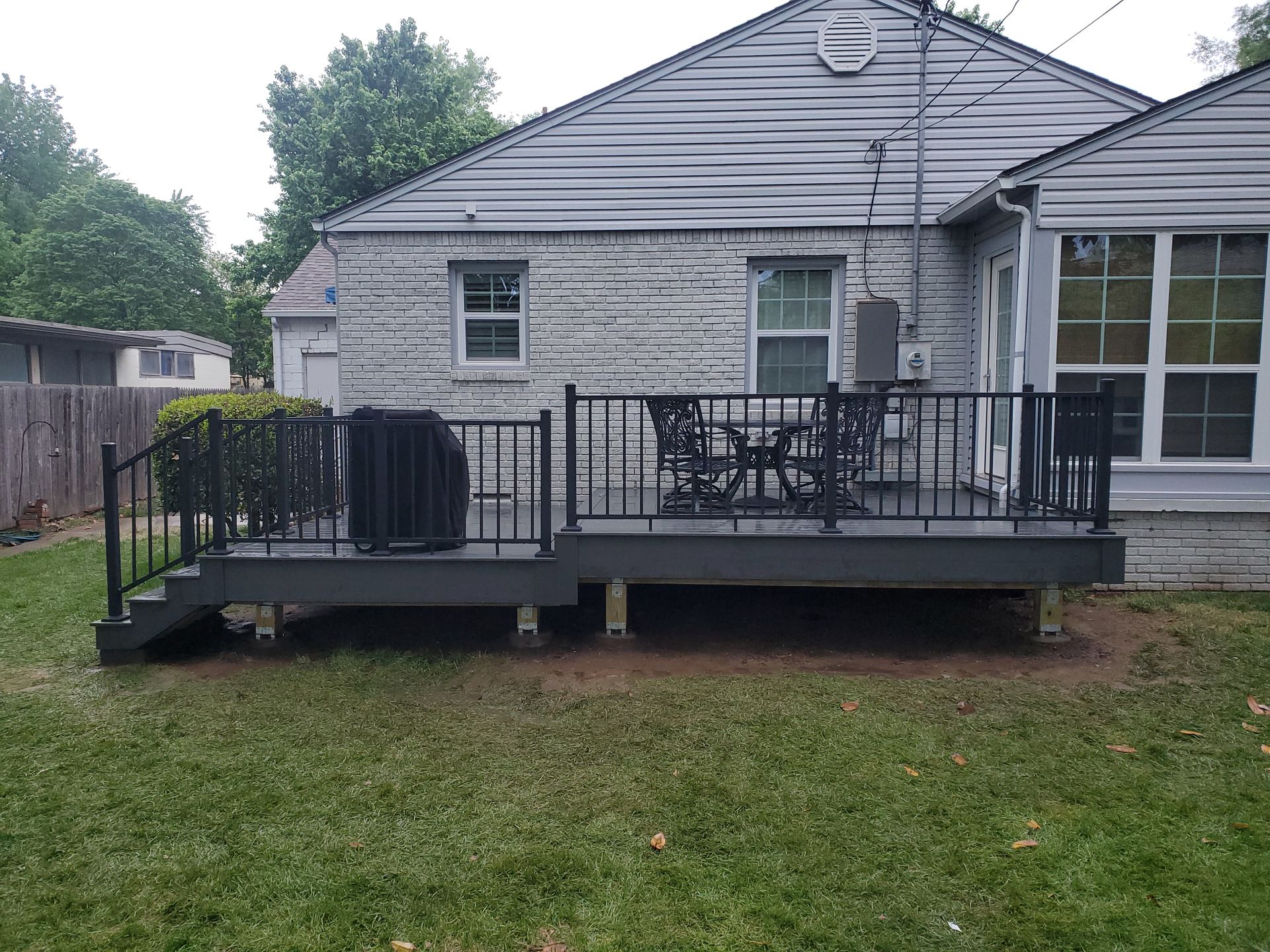 A house with a large deck in front of it.