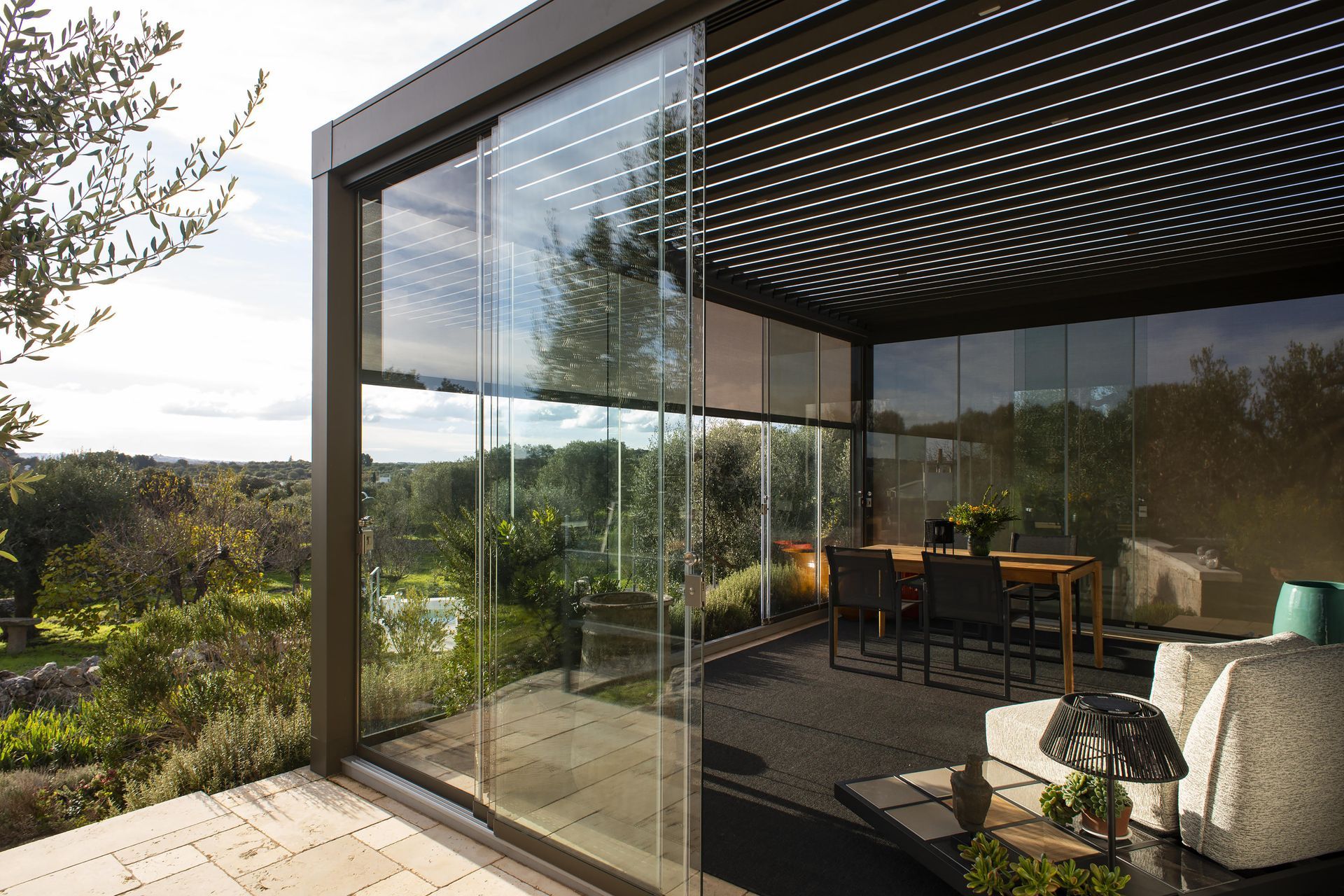 A patio with sliding glass doors and a table and chairs