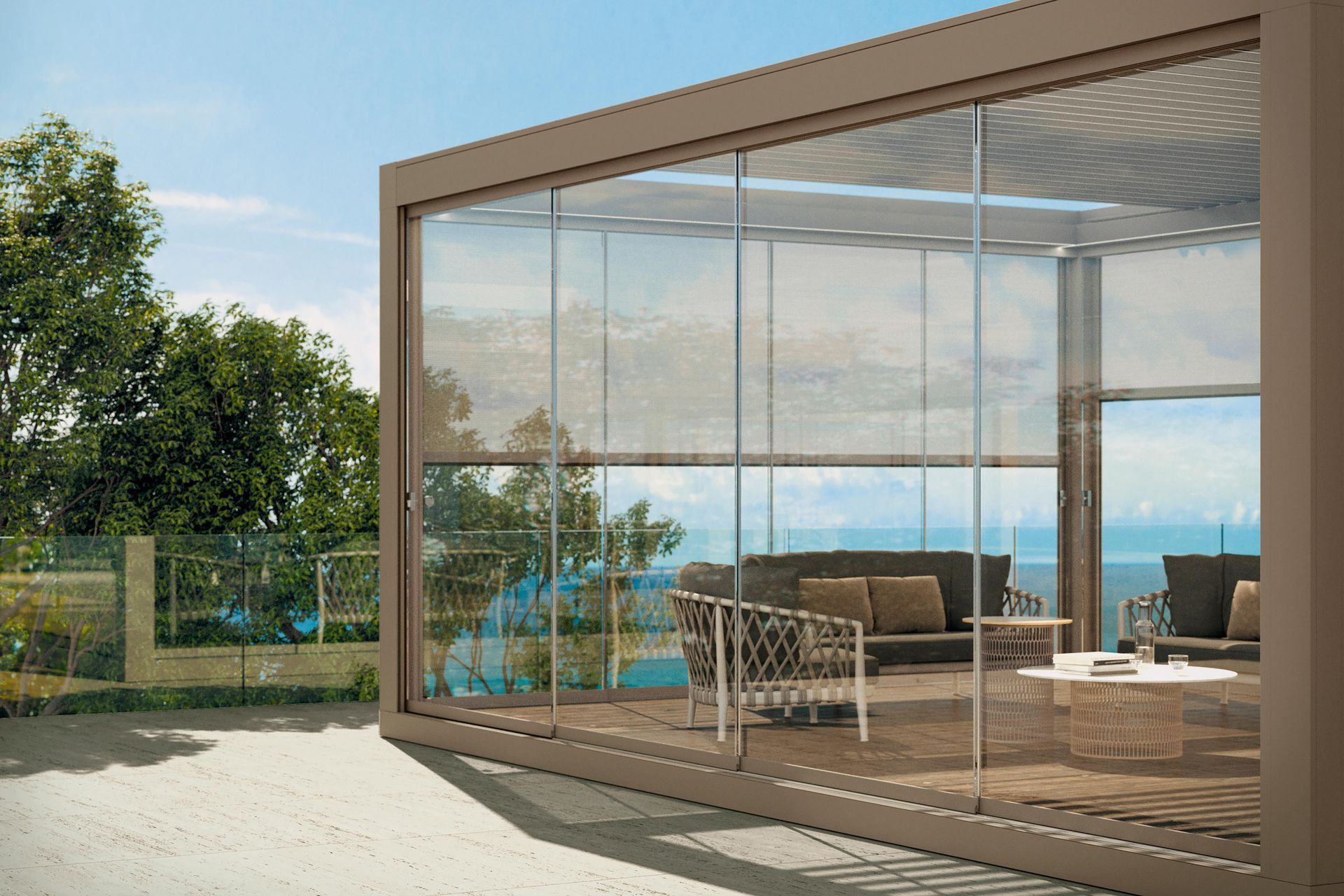A large glass building with a couch , chairs , and a table.
