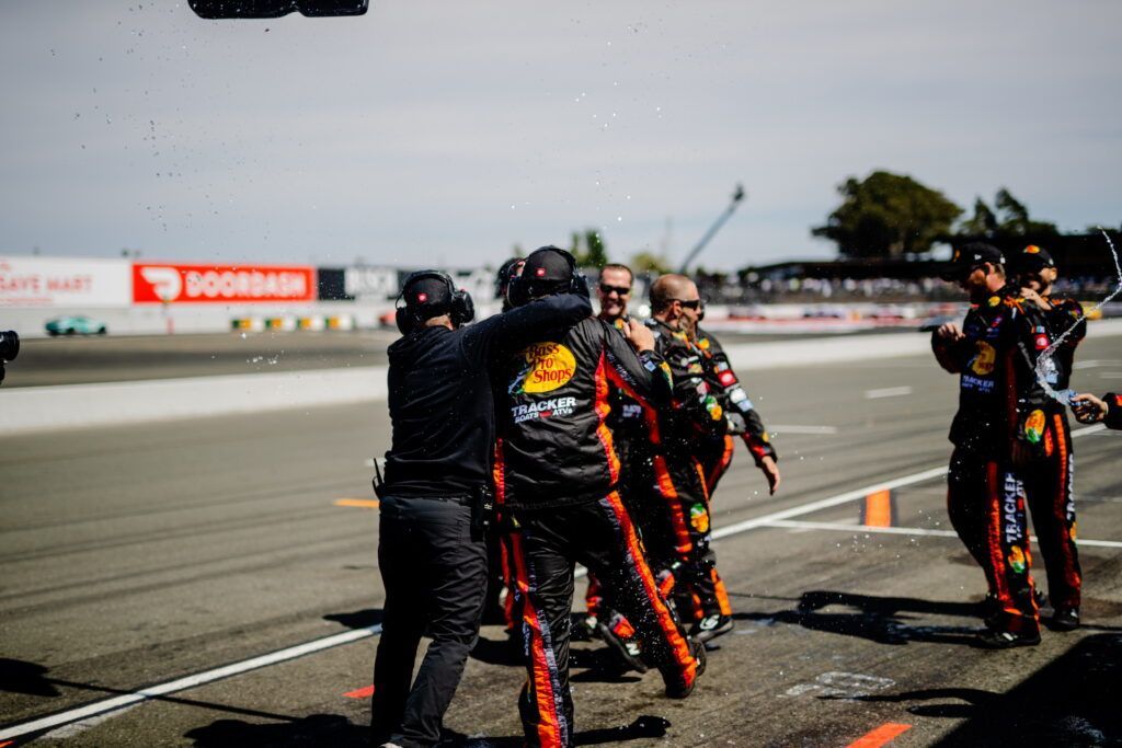 A group of people are standing on a race track.
