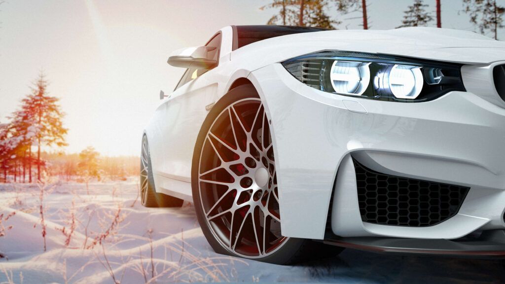A white sports car is parked in the snow.