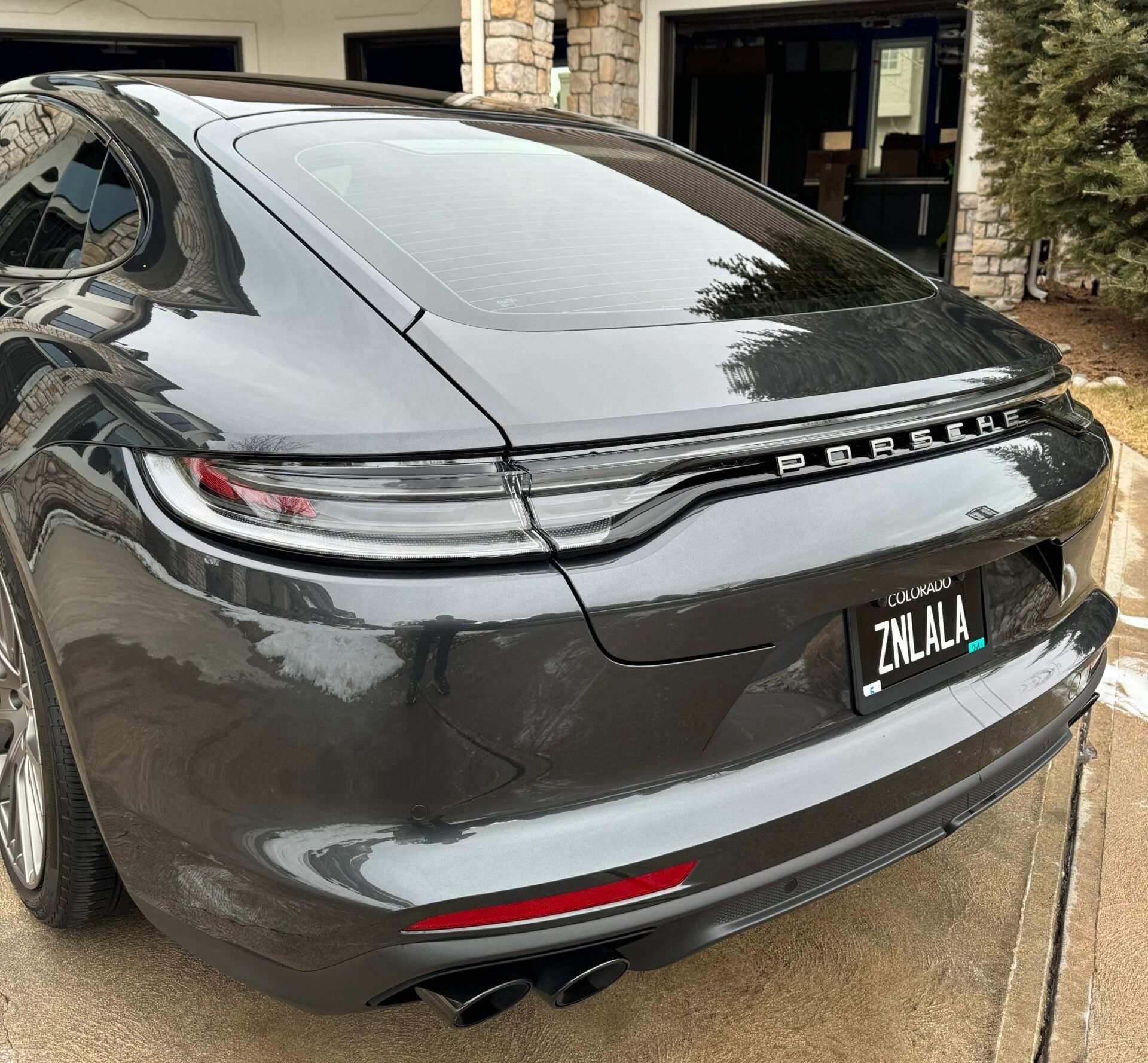 A black car with a license plate that says zklala