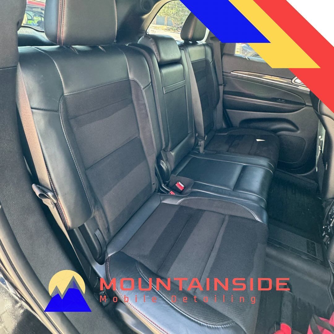 The back seat of a car with the words mountain inside on it