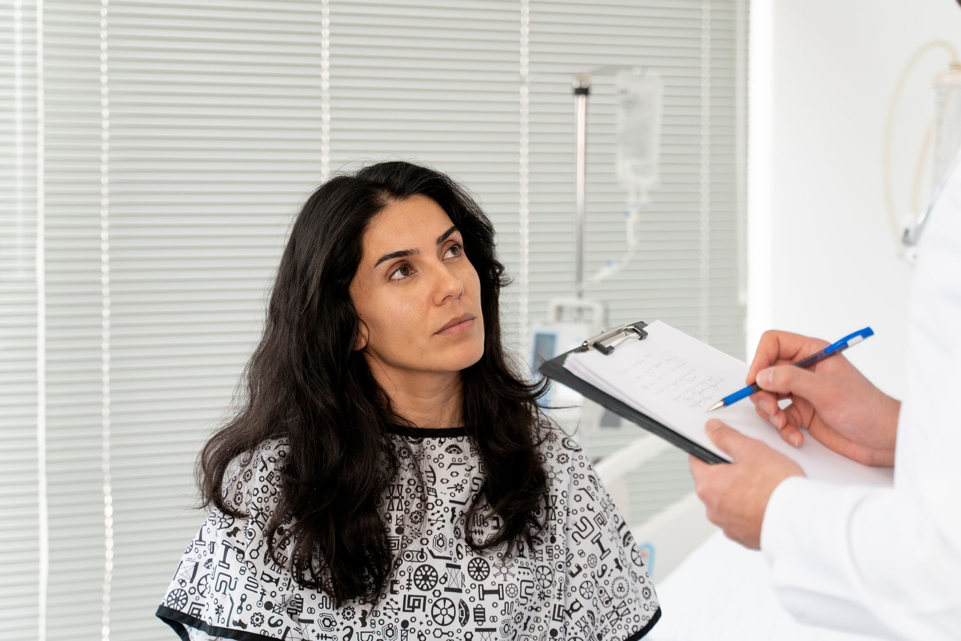 Patient speaking with doctor during a medical consultation in a bright exam room