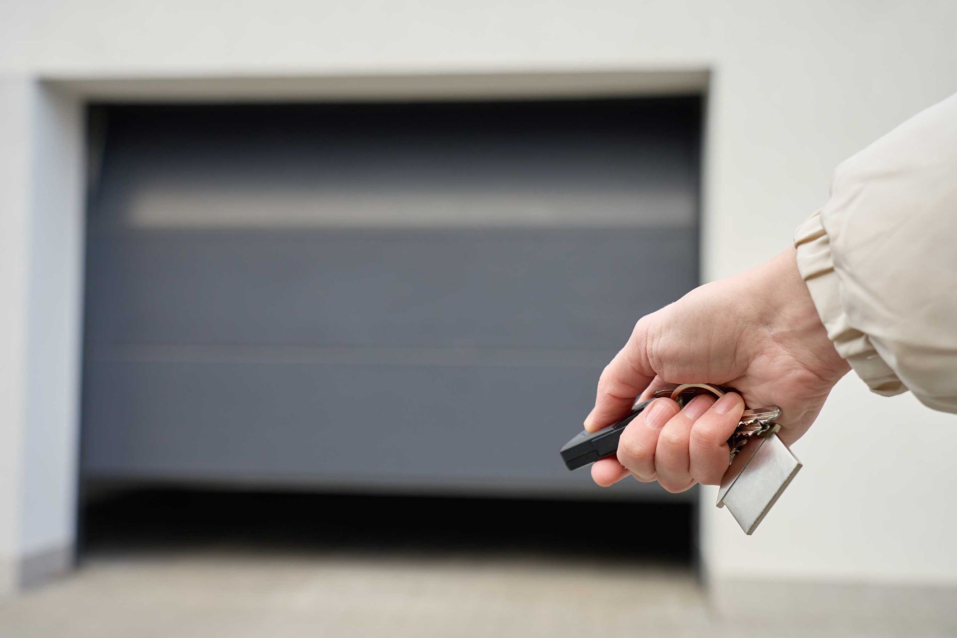 Finger on remote, garage door closed tight, modern home security and convenience. Finger on remote, garage door closed tight, modern home security and convenience.