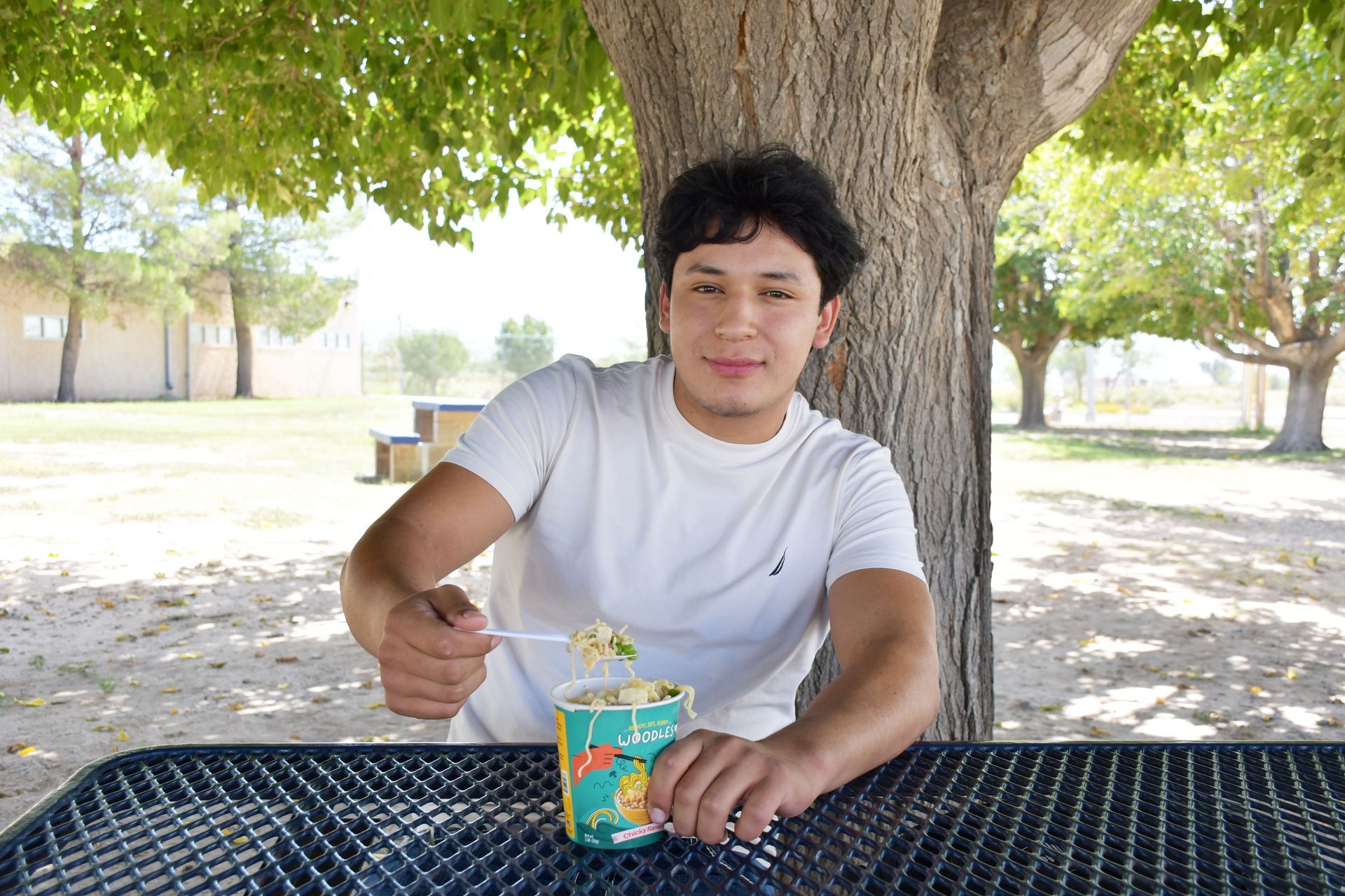 Student holds cup of instant noodles.