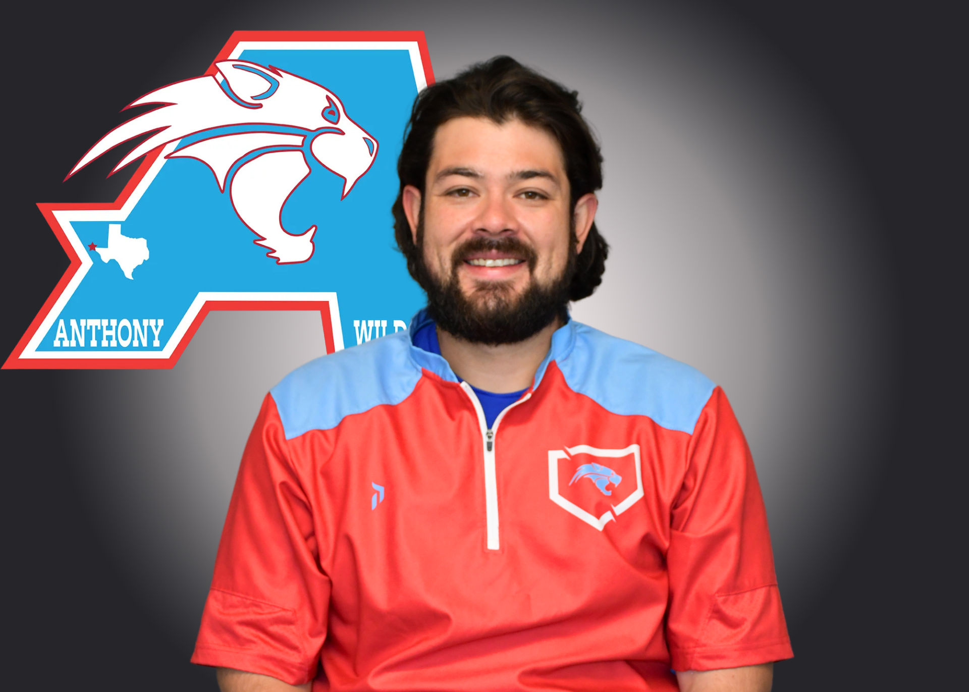 James Puga stands in front of Anthony Athletics logo