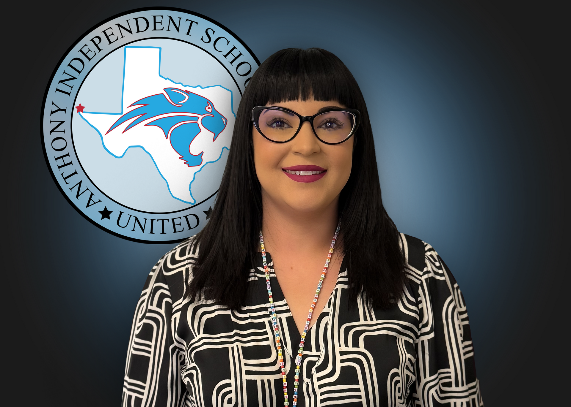 A woman stands in front of an independent school logo