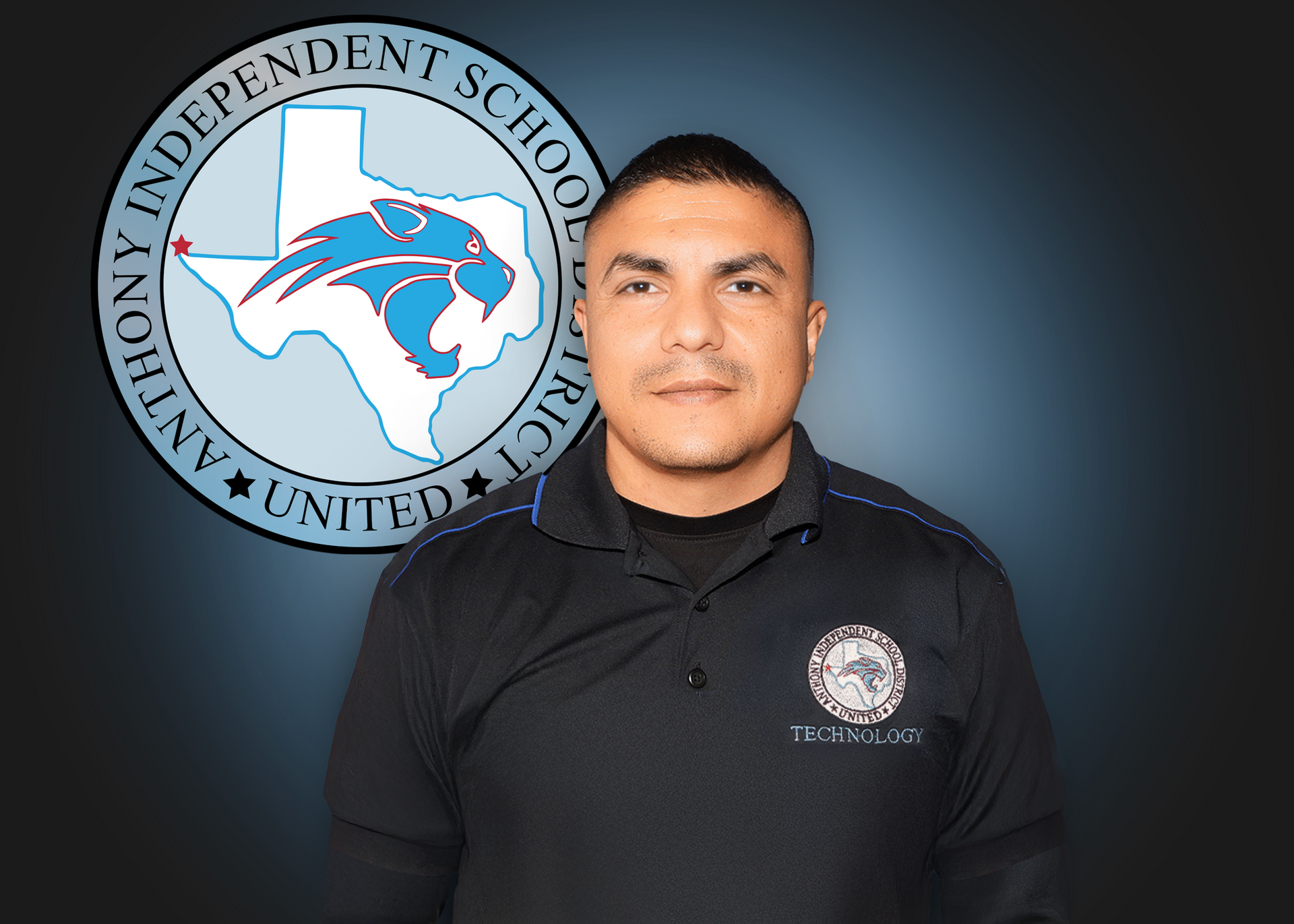 A man is standing in front of an independent school district logo