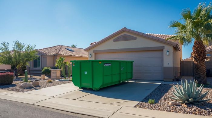 Green roll off dumpster placed in a Surprise, AZ driveway for a home cleanup or remodeling project, showing a clean and easy setup for residential dumpster rentals.