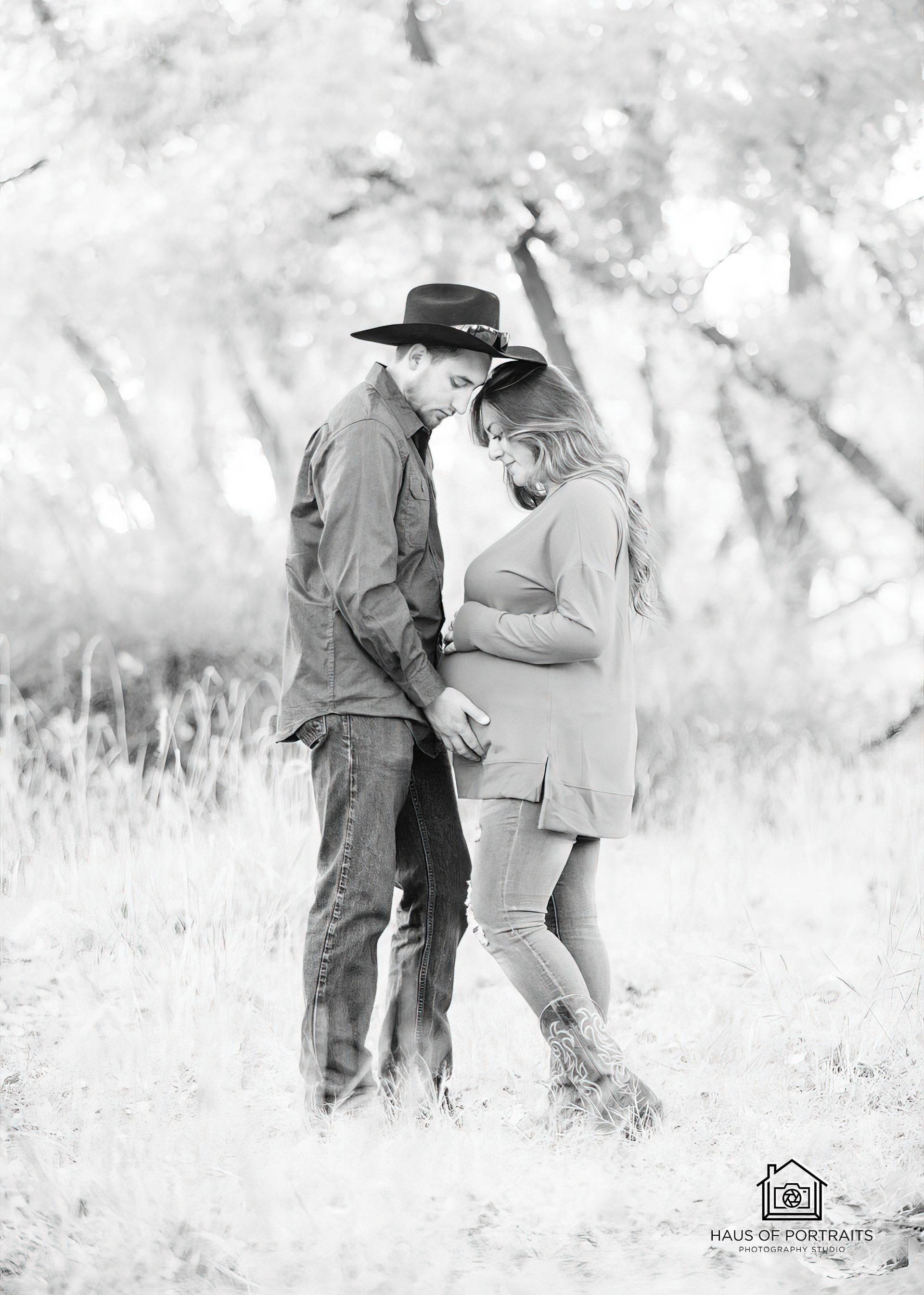 Couple standing close in a bright field, touching foreheads